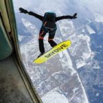 10,000-Foot Nightmare, Astonishing Comeback Skydiver jumps from plane with a skysurf board over snowy landscape