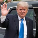 Clock Ticks: Trump Freezes Canada Hit Donald Trump waves while standing beside a black vehicle