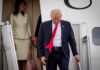 Sudden Schedule Shake-Up: What Spooked Trump? man in suit with red tie walking down airplane stairs