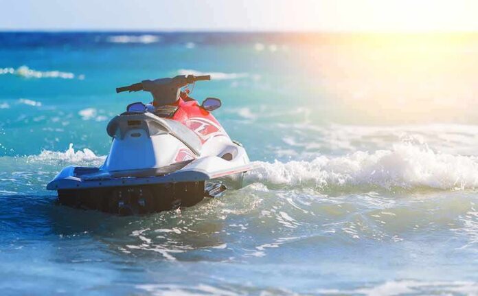 Jet ski on turquoise ocean waves near shore