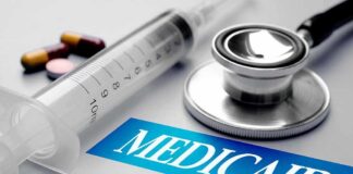 Stethoscope and syringe beside Medicaid label