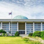 Trump Freezes War Games — What’s He Betting? Parliament building with a green dome and flagpoles
