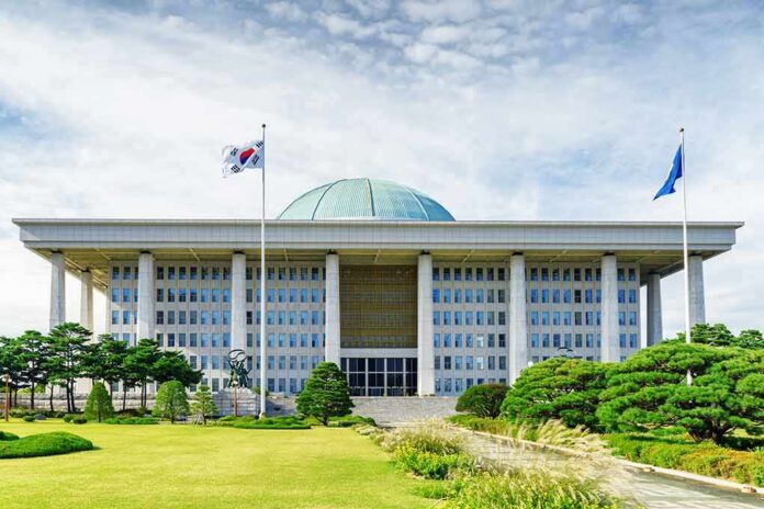shutterstock_749891683 Parliament building with a green dome and flagpoles