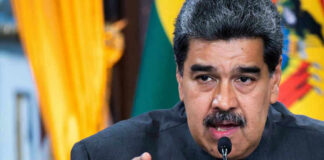 Nicolás Maduro speaking at a podium, pointing forward