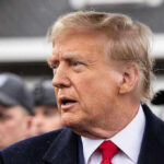 Spin Machine Targets Trump’s Temple Donald Trump in profile with Brendan Steele and Jonathan Crompton blurred in the background