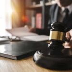 Frat House Nightmare Triggers Grand Jury Judge's gavel on desk with person reading documents in background