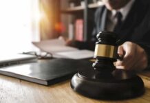 Frat House Nightmare Triggers Grand Jury Judge's gavel on desk with person reading documents in background