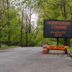 Governor Issues Urgent Evacuations Portable electronic road sign on a quiet tree-lined street
