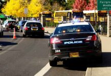 Campus Terror: Bend Elementary Turns Deadly Police cars with lights on near school buses on a city street
