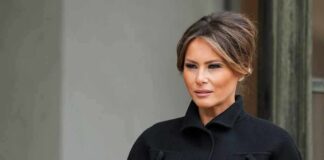 Melania Trump in a black coat looking to the side
