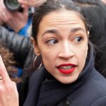 woman with red lipstick in a crowd turning her head