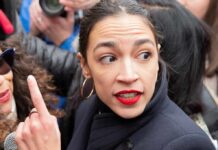 woman with red lipstick in a crowd turning her head