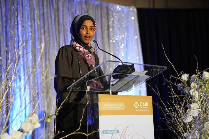 Ilhan Omar speaking at a podium on a decorated stage