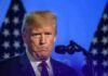 Doxxing Drama: Republicans Turn On Trump Donald Trump at a podium with U.S. flags in the background