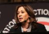 Husband Pushback Rattles Harris 2028 Kamala Harris speaking at a podium with a microphone