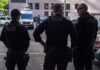 Police officers stand on a city street