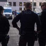 Sixty Entries, One Log, and Plenty of Questions Police officers stand on a city street