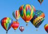 Colorful hot air balloons floating in a clear blue sky