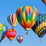 Live Wires, Falling Balloon – Then Silence Colorful hot air balloons floating in a clear blue sky
