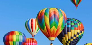Colorful hot air balloons floating in a clear blue sky