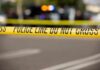 Police tape cordons off a street