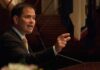 Marco Rubio speaking at a podium and gesturing with his hand