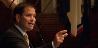 Marco Rubio speaking at a podium and gesturing with his hand