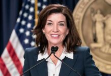 Campus Scandal: Why Albany Just Jumped In woman speaking at a podium with microphones