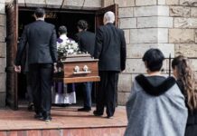 Hollywood Mourns – But His True Fight Surprises Pallbearers carry a casket into a stone church