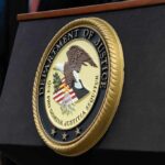 Sedition Convictions Vanish – Who Killed Them? Department of Justice seal on a podium