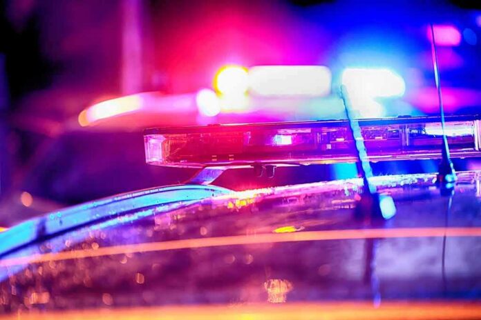 shutterstock_2304350799 Police car light bar flashing at night
