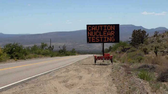 shutterstock_449022109 Electronic roadside sign warning of nuclear testing in desert