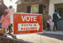 Canceled. No Cash. Who Took The $25M? Red voting sign with arrow near people entering a polling place