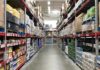 Warehouse aisle with tall shelves stacked with boxes and bulk goods
