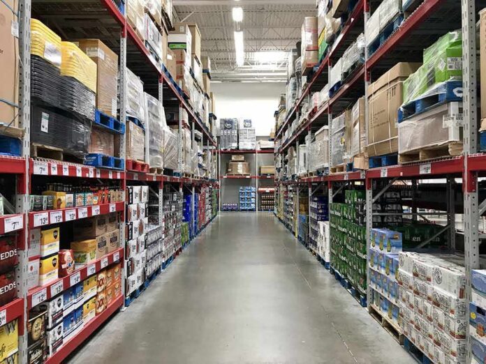 Warehouse aisle with tall shelves stacked with boxes and bulk goods