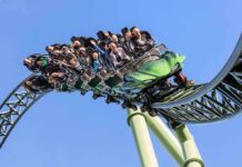 roller coaster train with riders on a curved track