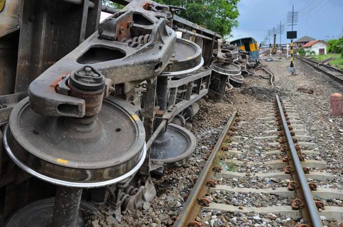 shutterstock_675668563 Overturned train cars beside railway tracks