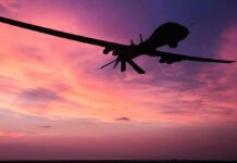 Domestic Shield Ramps Up – Why Now? drone silhouette flying against a pink and purple sunset sky