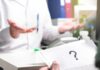 A Campaign Absence Draws Fresh Questions About Timing Doctor gesturing during consultation with patient holding paper with question mark