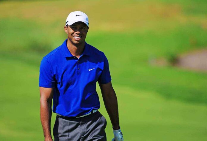 Sydney,-,Nov,12:,American,Tiger,Woods,Smiles,To,The Tiger Woods smiling on a golf course in a blue polo
