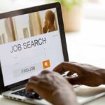 Person using laptop for job search.