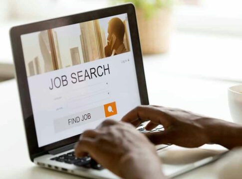 Person using laptop for job search.