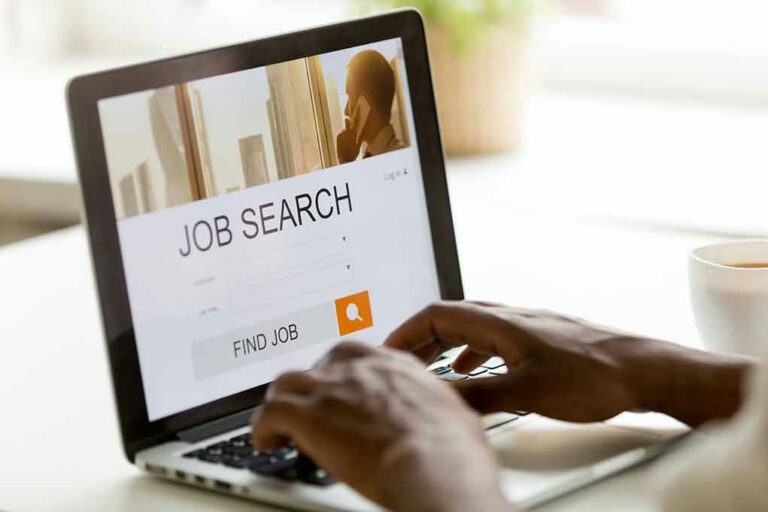 Person using laptop for job search.