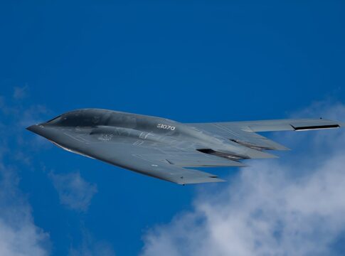 Stealth bomber flying against a clear blue sky