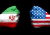 Two fists painted with Iran and USA flags.