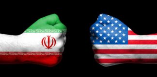 Two fists painted with Iran and USA flags.