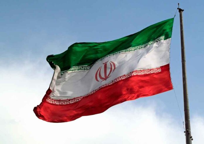 1088416085 featured image Iranian flag flying against a clear sky.