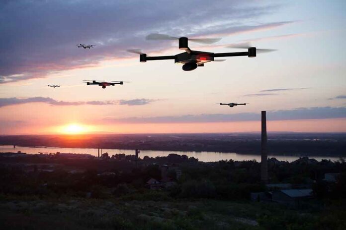 1143966755 featured image Drones flying at sunset over a landscape.