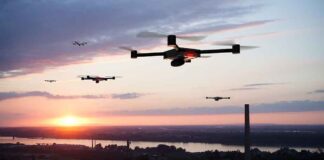 Drones flying at sunset over a landscape.