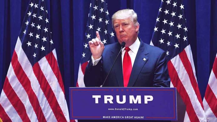 1456399979 featured image Politician speaking at podium with American flags behind.